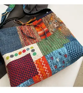Detail of bohemian patchwork tote bag with red checkerboard and floral embroidery patterns