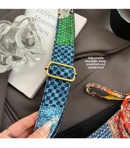 Detail of bohemian tote bag showing adjustable woven strap with blue pattern and gold buckle