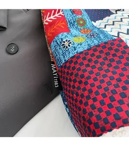 Detail of bohemian canvas tote featuring colorful patchwork patterns and logo label