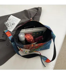 Detail view of large canvas tote bag interior with multiple items showing large capacity