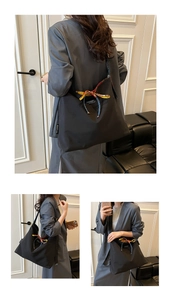 Detail of black canvas tote bag with fashion tag and colorful silk ribbon decoration