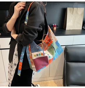 Detail of bohemian patchwork canvas tote bag with vibrant geometric and floral patterns