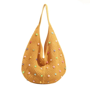 Yellow knit tote bag with colorful faux pearls and crochet net design for beach vacation