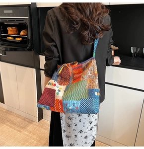Detail of bohemian patchwork tote bag with various patterns and durable canvas texture