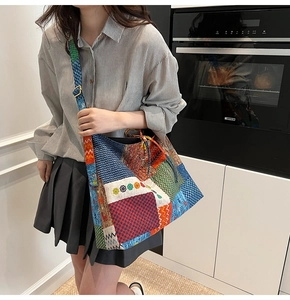 Detail of colorful patchwork canvas tote bag with bohemian patterns and wide strap