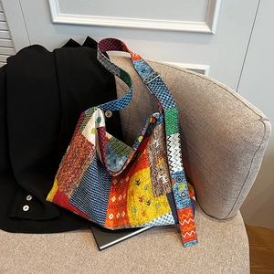 Close-up of bohemian patchwork hobo bag showing colorful ethnic patterns and metal buckle