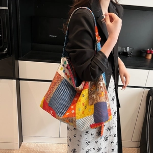 Detail of bohemian patchwork tote bag worn by model in a modern lifestyle setting