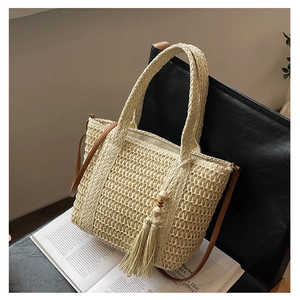 Detailed texture of handwoven straw tote bag with elegant tassel and wooden bead decor