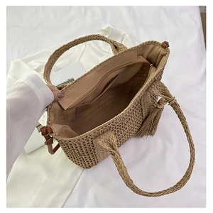 Top view of large straw tote bag with interior fabric lining and functional zipper pocket