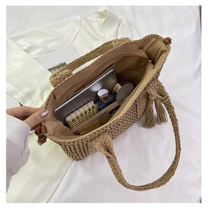 Detail view of large straw tote interior showing spacious capacity and secure zipper