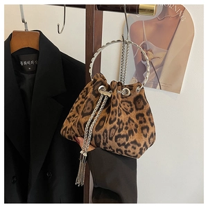 Detail of leopard print bucket bag with silver metal ring handle and chain tassels