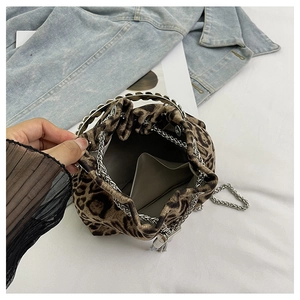 Top view of leopard print bucket bag interior showing metal handle and chain strap