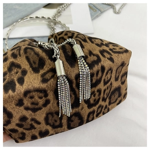 Detail of leopard print bucket bag with silver ring handle and sparkling rhinestone tassels