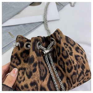 Detailed close-up of leopard print bucket bag with silver metal chain and drawstring