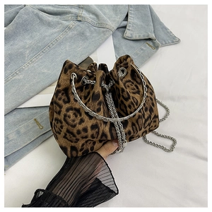 Detail of leopard print bucket bag featuring silver ring handle and chain strap