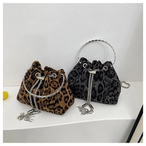Close-up of leopard print bucket bags with metal ring handles and tassel chain details