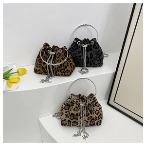 Three leopard print bucket bags with metal ring handles and tassel chain details
