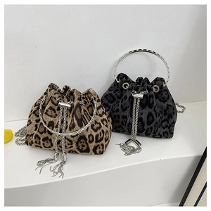 Detailed view of leopard print bucket bags with silver metal handles and chain tassels