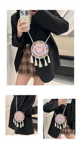 Close-up of handmade woven round bag with colorful beaded smiley face and long tassels