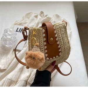 Détail du sac en paille tissé main avec rabat en cuir et charm peluche mignon