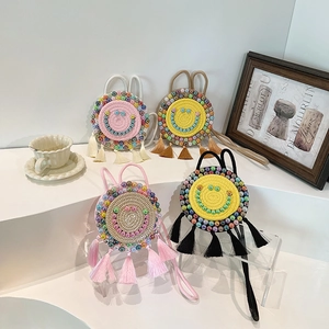 Handwoven round crossbody bags with beaded smiley faces and tassels in four colors