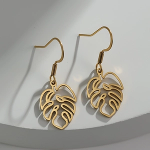 Bohemian 18K gold plated stainless steel monstera leaf drop earrings on white stone