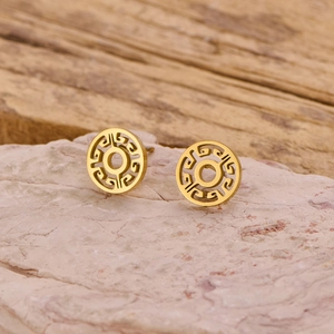 Detailed view of gold circular earrings with hollow geometric patterns on stone