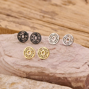 Three pairs of geometric round hollow stud earrings in gold, silver, and black steel