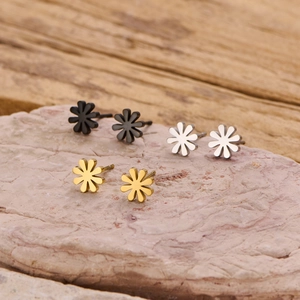Three pairs of mini stainless steel flower stud earrings in black, silver, and gold finish