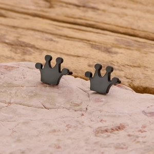 Macro shot of matte black crown earrings showing detailed craftsmanship and texture