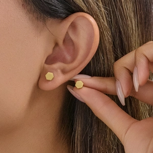 Minimalist geometric hexagon stud earrings in matte gold finish for a modern look