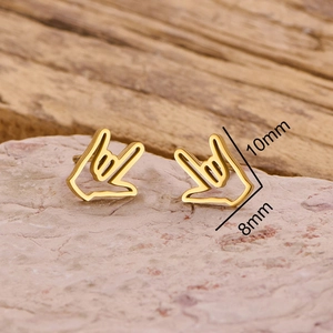 Minimalist gold gesture hand stud earrings in stainless steel on natural stone base
