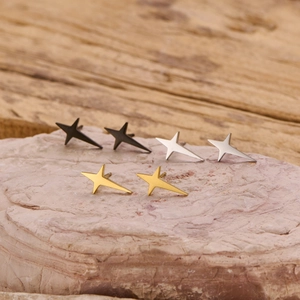 Minimalist stainless steel star stud earrings in gold, silver and black on natural stone