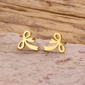Detailed view of golden irregular ribbon bow earrings with a polished mirror finish
