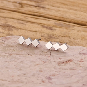 Polished silver geometric stainless steel stud earrings featuring triple rhombus design