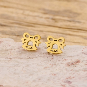 Close-up of golden bow-knot bell stud earrings on a textured stone surface