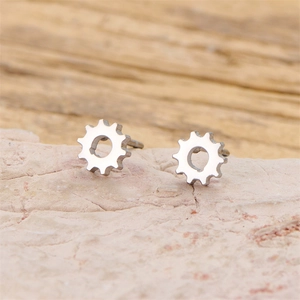 Minimalist silver gear-shaped stainless steel stud earrings with polished industrial style