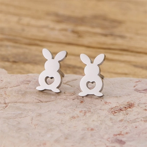 Minimalist silver rabbit stud earrings with heart cutout on textured stone
