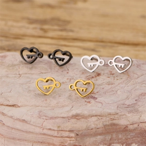 Three pairs of heart and key stud earrings in black, gold, and silver stainless steel