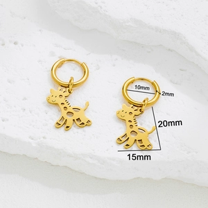 Golden giraffe pendant hoop earrings in stainless steel on white stone background