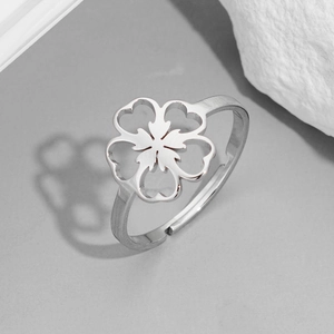 Detail of silver cherry blossom ring with matte brushed texture and open adjustable band