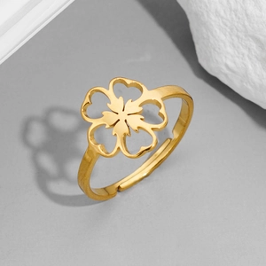 Detail of adjustable gold-plated ring showing cutout heart flower petals and metal luster