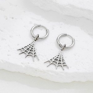 Retro spider web pendant hoop earrings in stainless steel on a white stone background