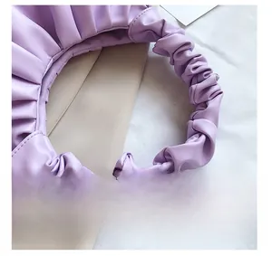 Detailed close-up of light purple ruched shoulder strap with elastic cloud pleat texture