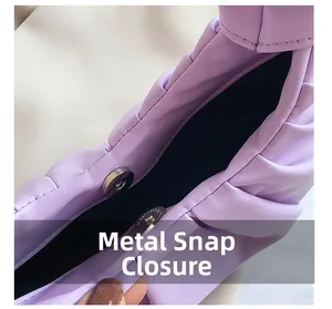 Detail view of the magnetic metal clasp and black interior lining of the purple cloud bag