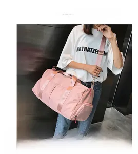 Pink sports gym bag with dry-wet separation and side shoe compartment shown on model