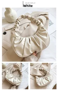 Detail of white PU cloud bag showing soft pleated handle and crescent fold design