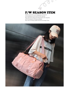 Pink waterproof gym bag with separate shoe compartment shown on shoulder with strap