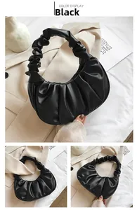 Detail of black pleated cloud bag showing soft PU leather texture and ruched handle