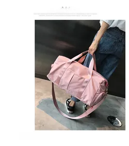 Pink fitness bag detail showing separate shoe compartment and durable nylon fabric texture